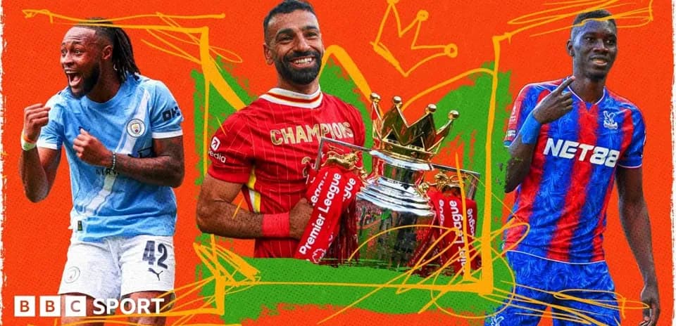 Three football players celebrating with trophies