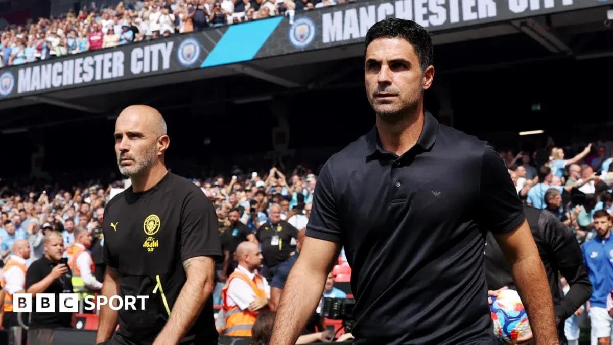 Coaches walking onto the pitch before match