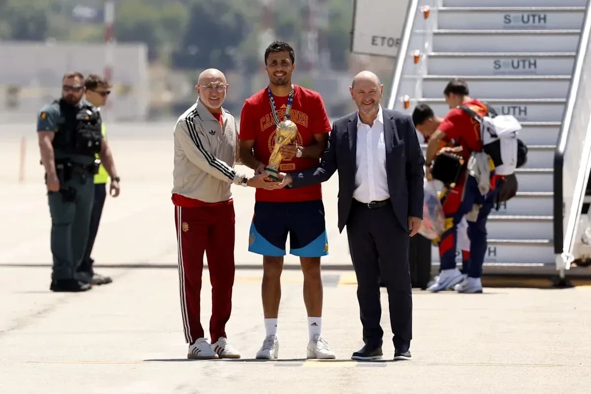 Player holding trophy with officials at airport