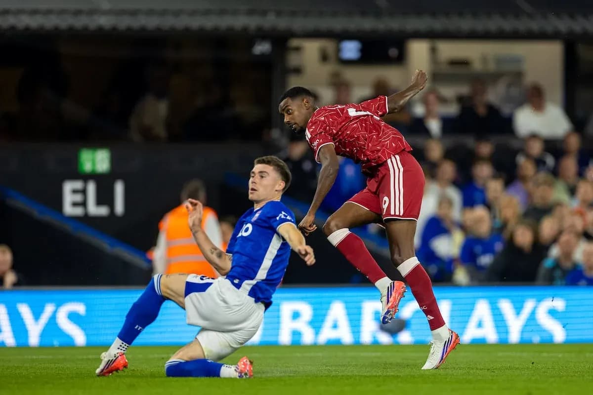 Player in red evading tackle from blue player