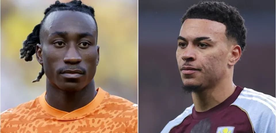 Two football players in match uniforms looking serious