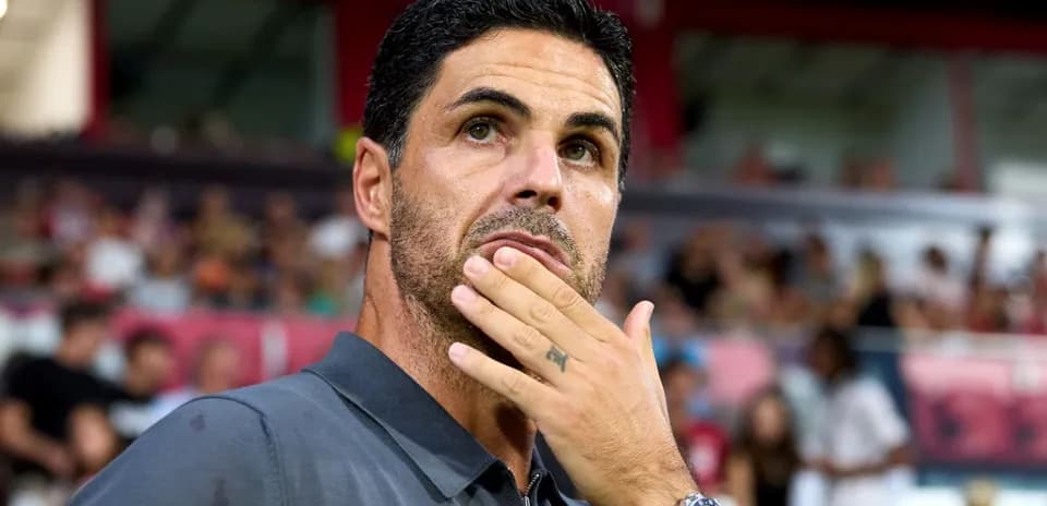 Coach observing the match with thoughtful expression
