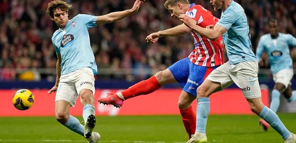 Atletico Madrid player kicking ball against Celta Vigo