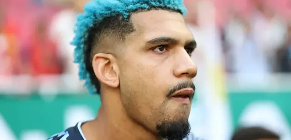 Player with blue hair in team jersey during match