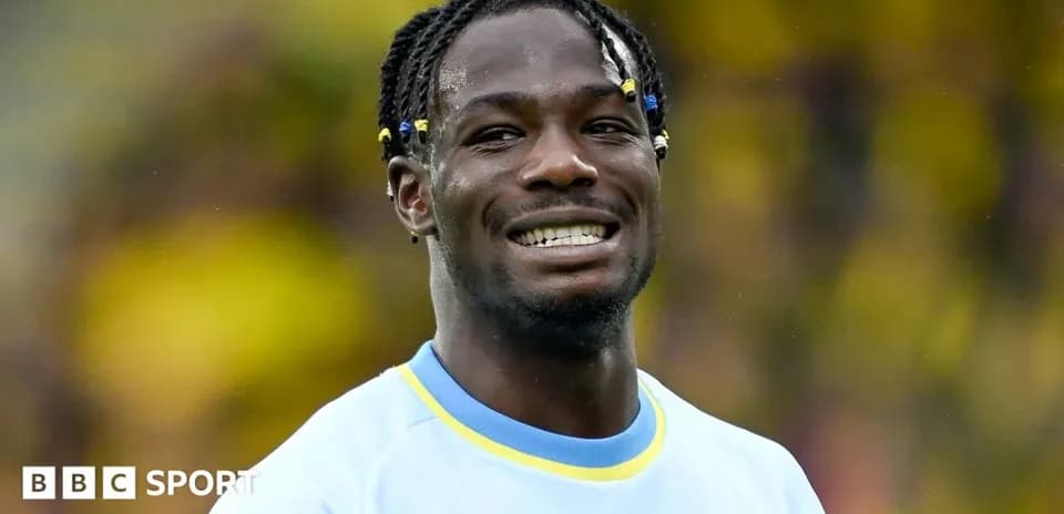 Player smiling during match warm-up on field