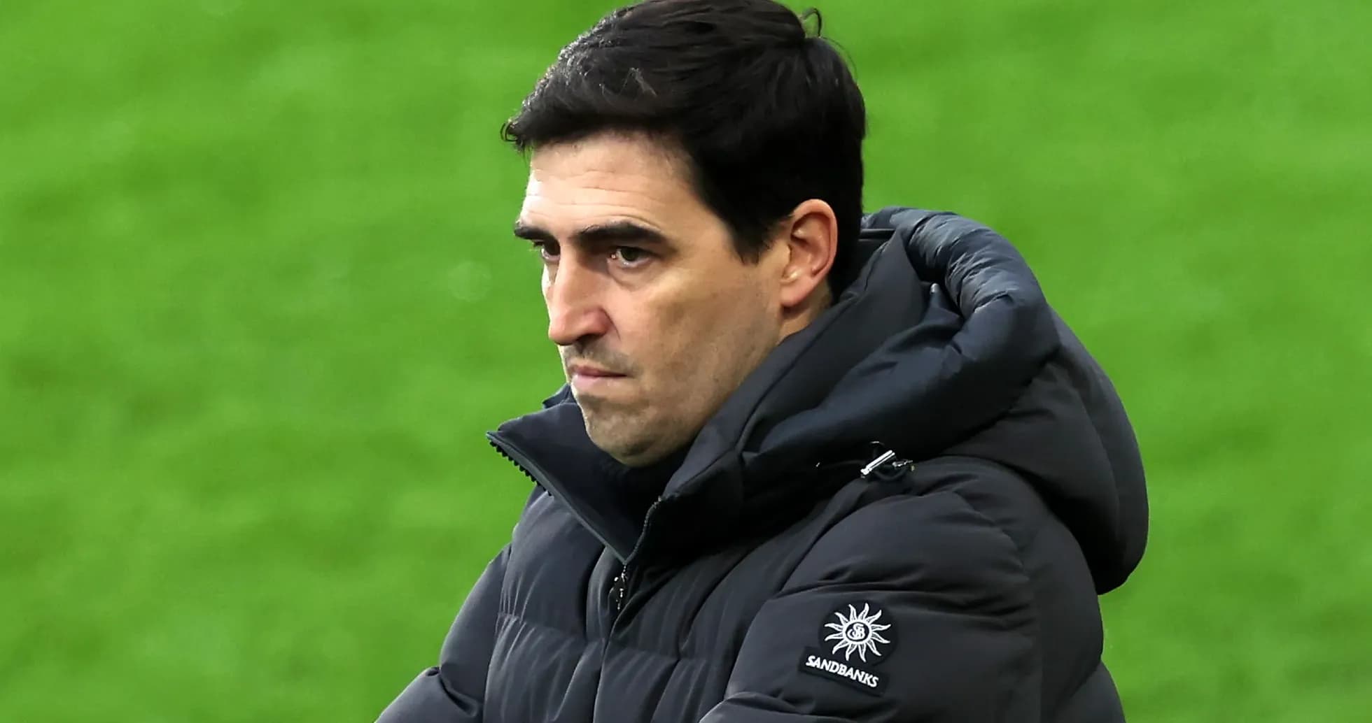 Coach observing the game with a serious expression