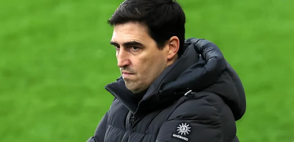 Coach observing the game with a serious expression