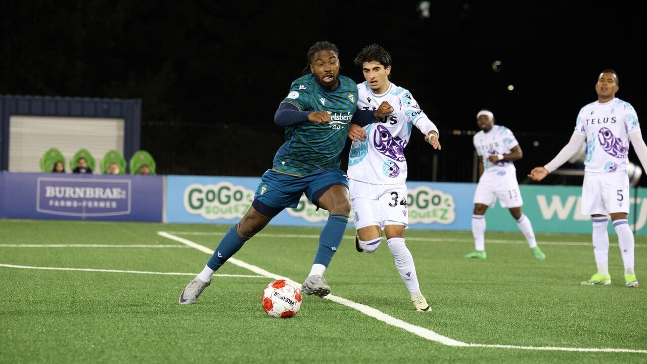 Player dribbling the ball in football match