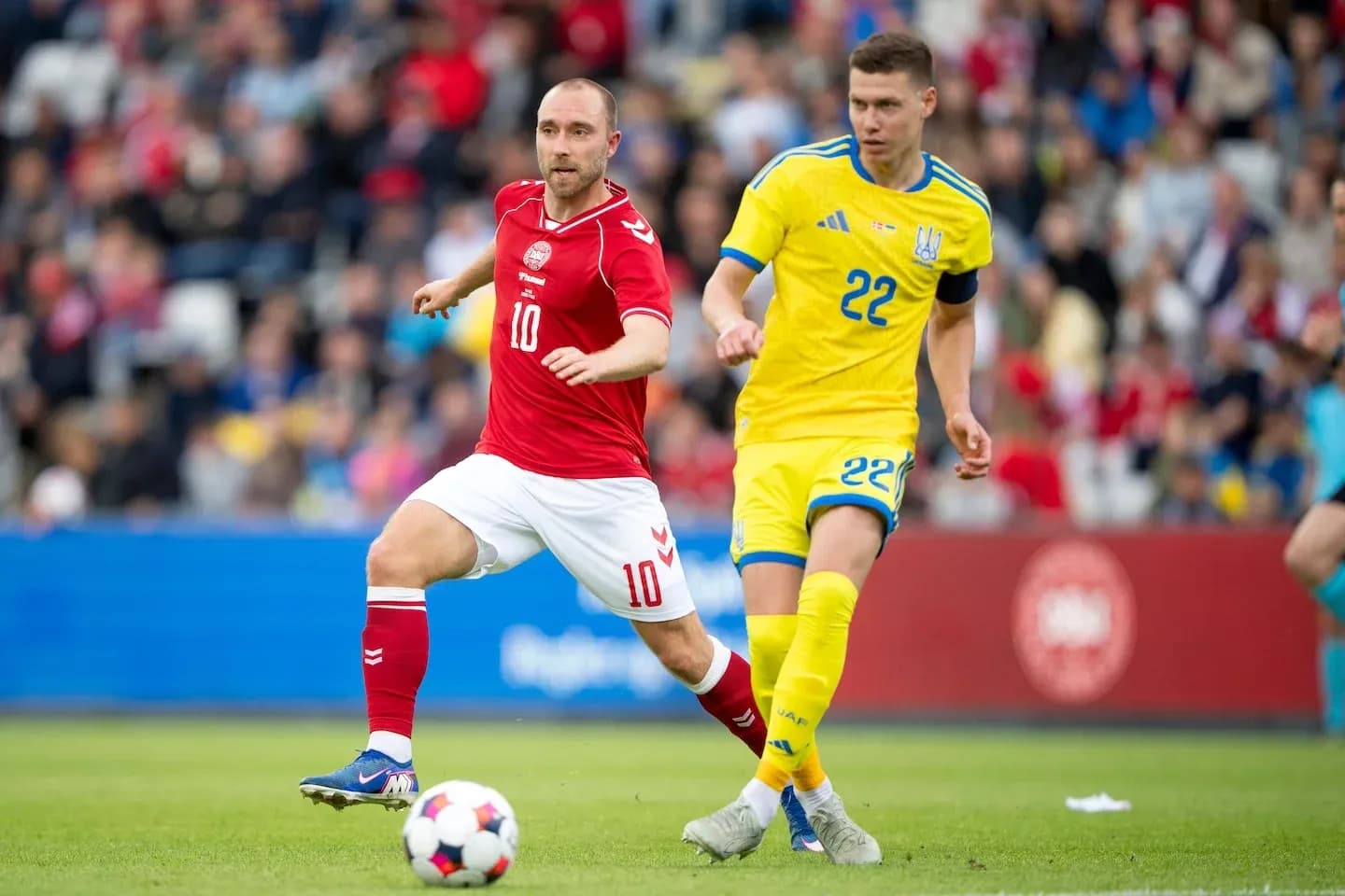 Denmark and Ukraine players competing for the ball