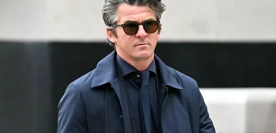 Man in sunglasses walking in stylish attire