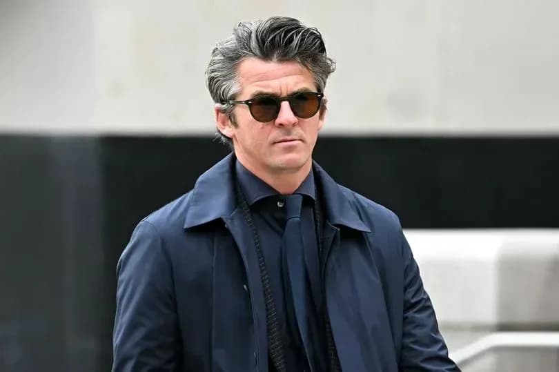 Man in sunglasses walking in stylish attire