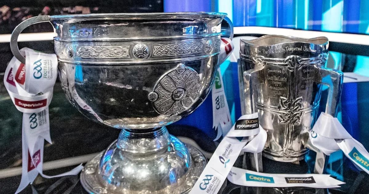 Two silver trophies with GAA ribbons displayed