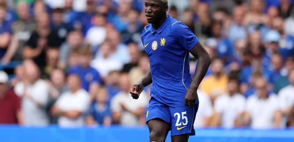 Player in blue Chelsea kit running on pitch