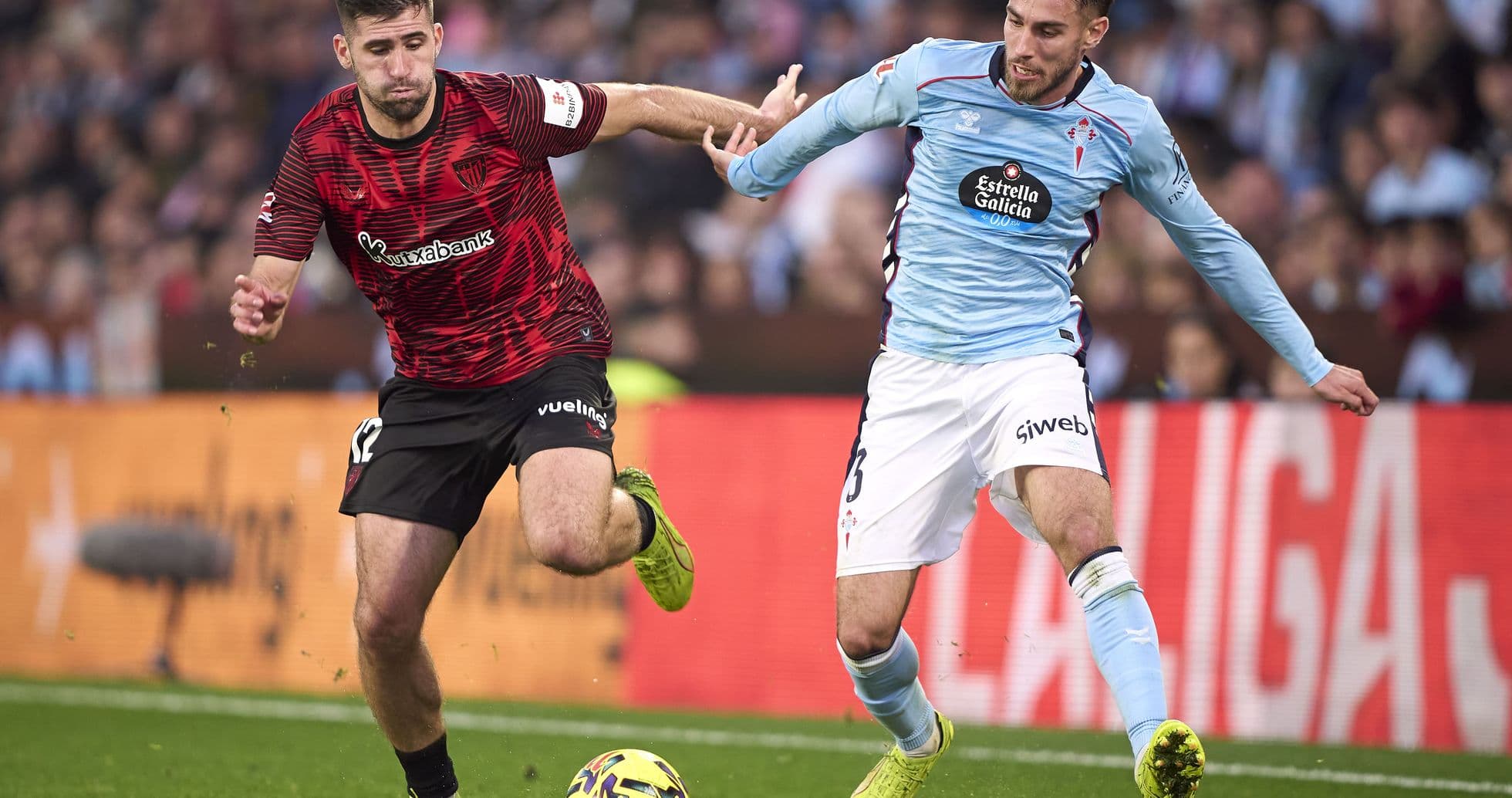 Athletic Club player challenging Celta Vigo opponent