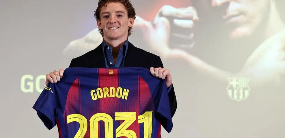 Player holding Barcelona jersey with name and number