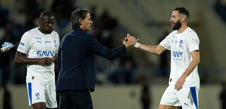 Coach shaking hands with player during match substitution