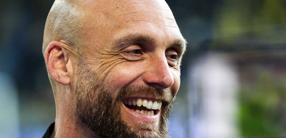 Smiling man with a beard and bald head