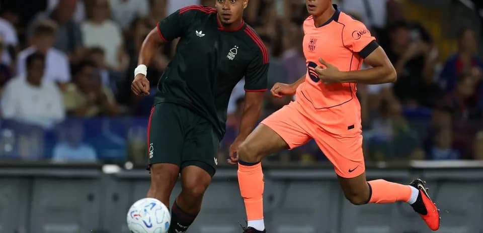 Two players running after the ball during match