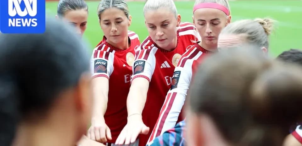 Players huddling before the match in team uniforms