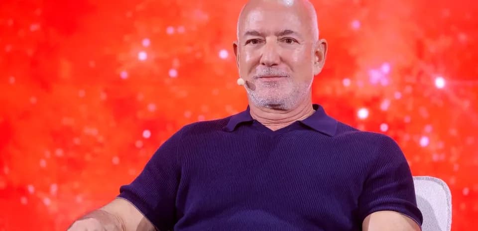 Person speaking at event with red background