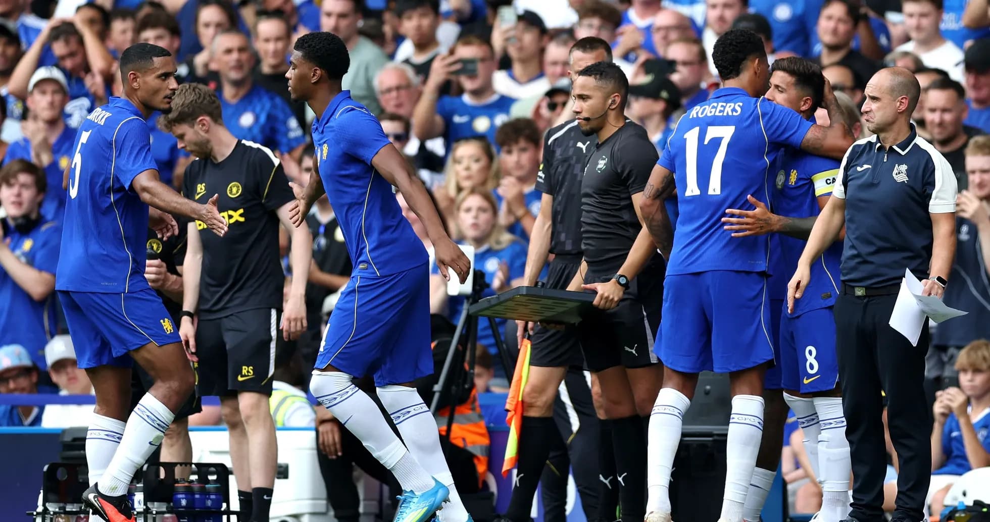 Players exchanging greetings during a substitution