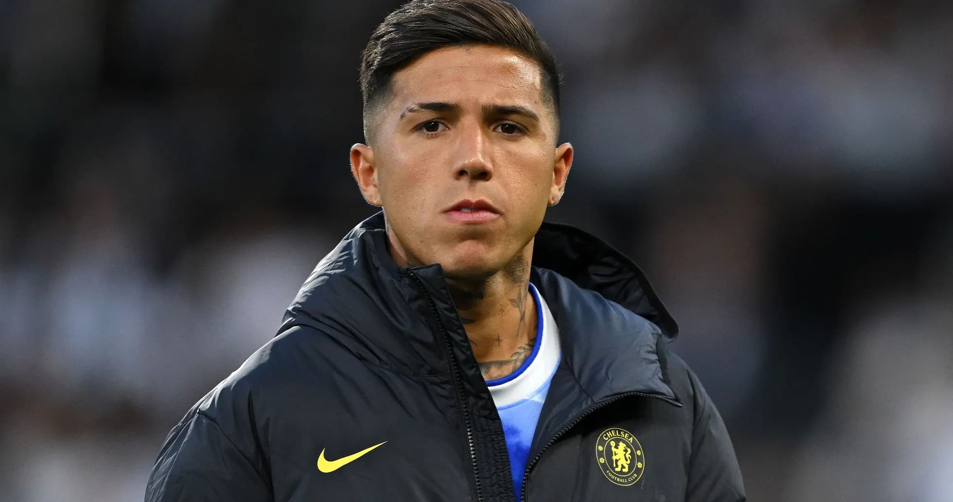 Player in Chelsea jacket during match warm-up