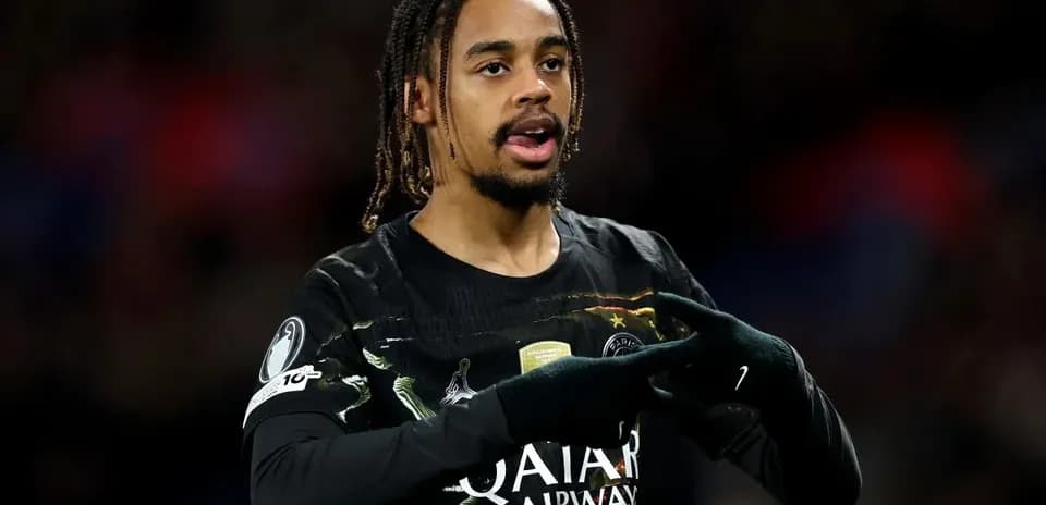 Player gesturing during match wearing PSG jersey