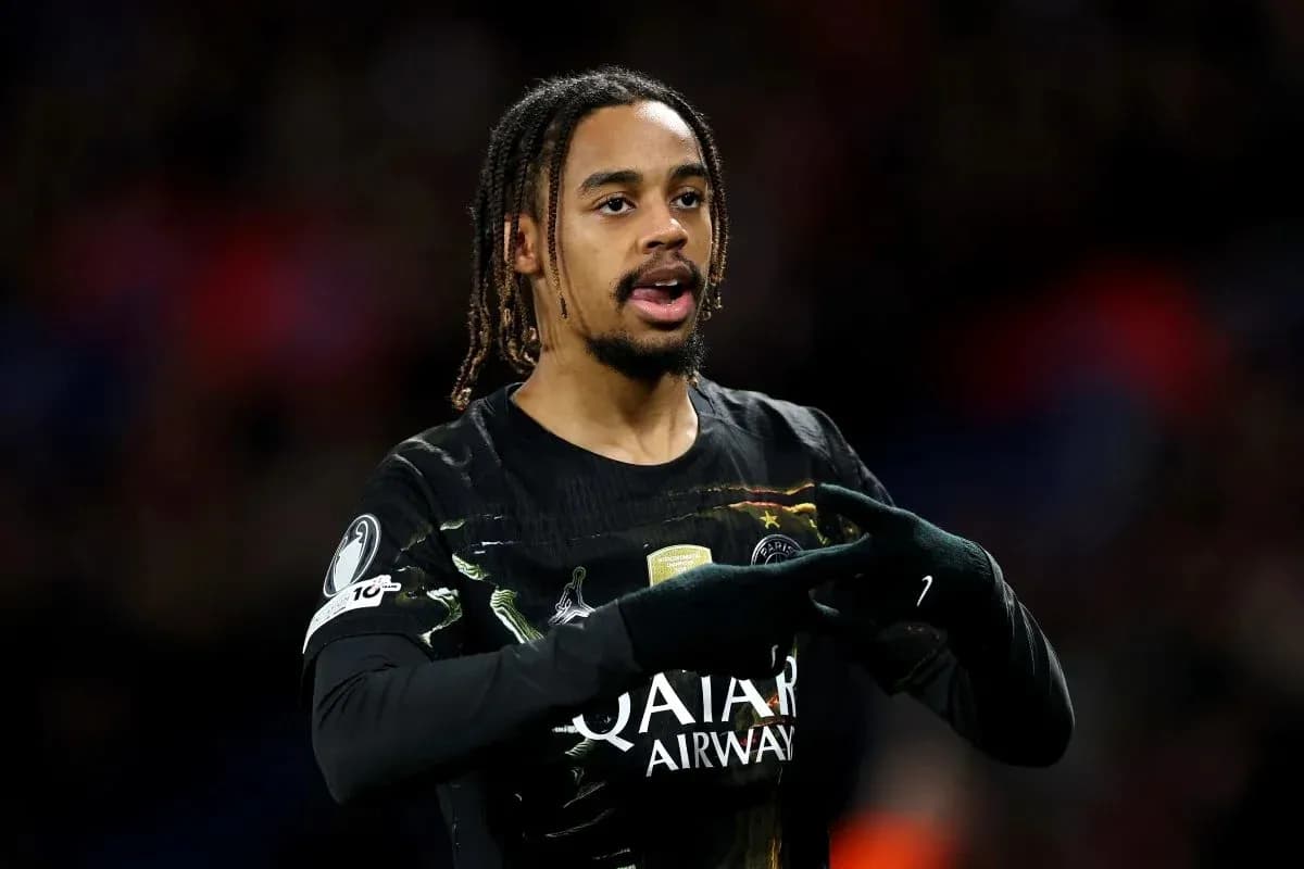 Player gesturing during match wearing PSG jersey