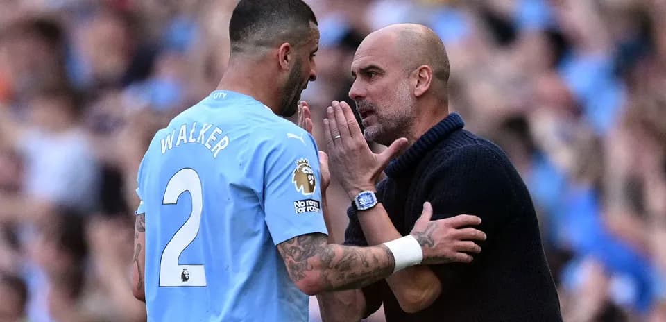 Kyle Walker and manager discussing on the pitch