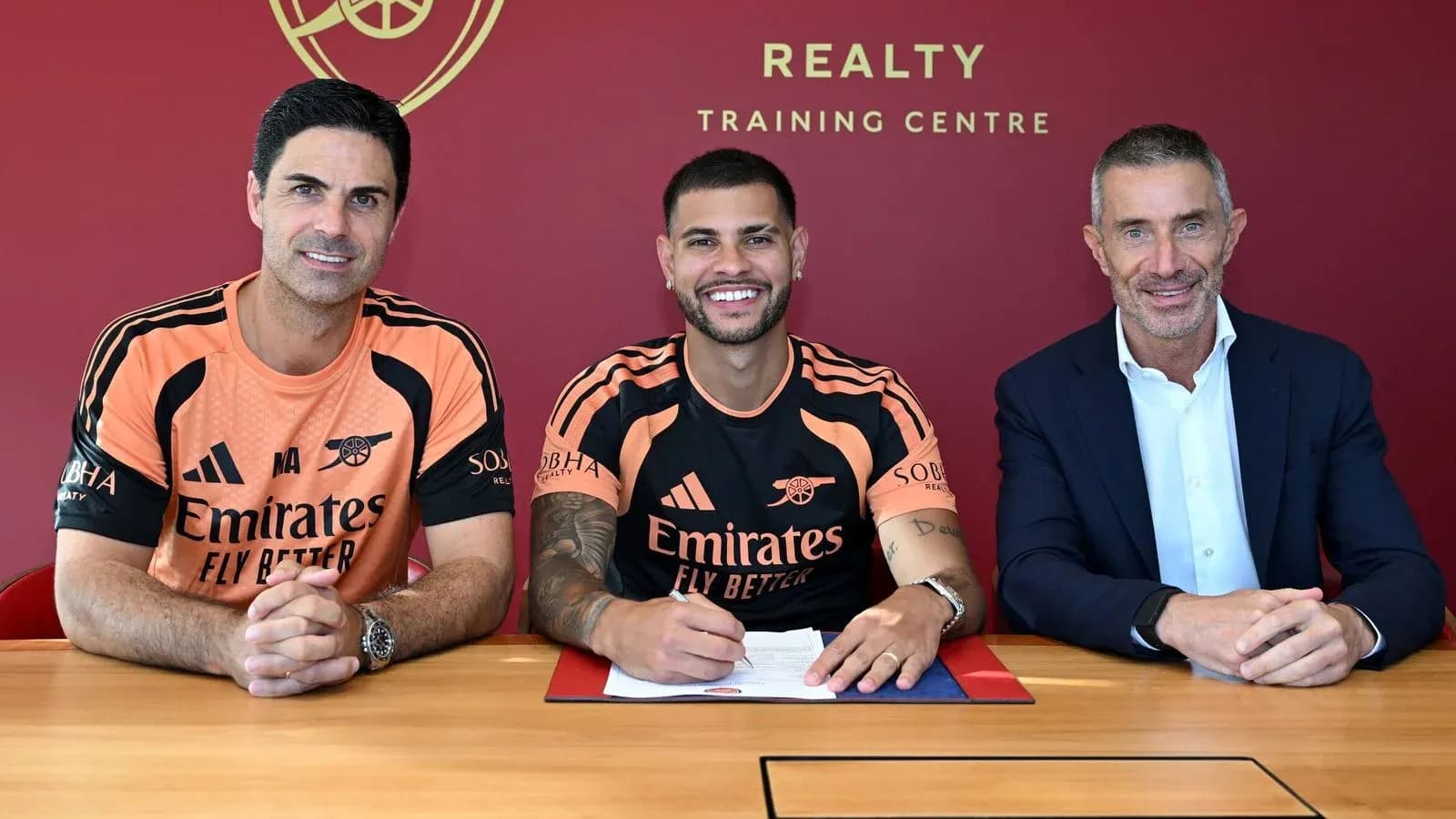 Player signing contract with club representatives at training center