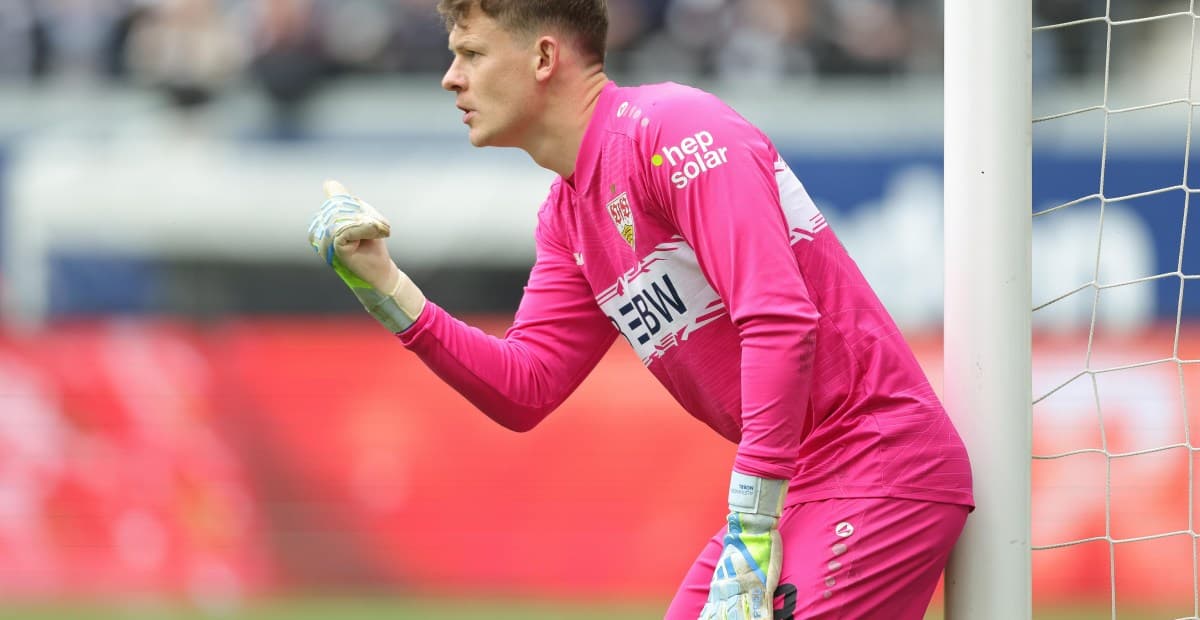Goalkeeper in pink kit gesturing during match