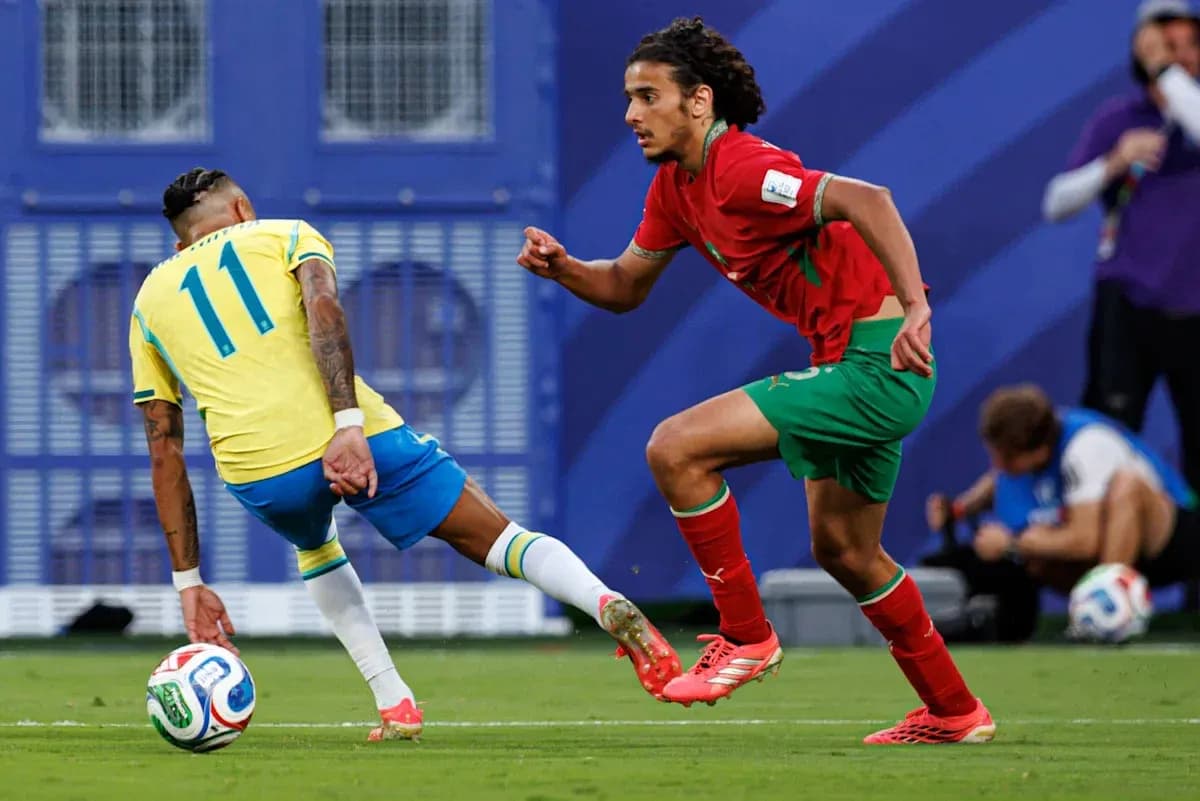 Player from Brazil dribbling past Moroccan defender