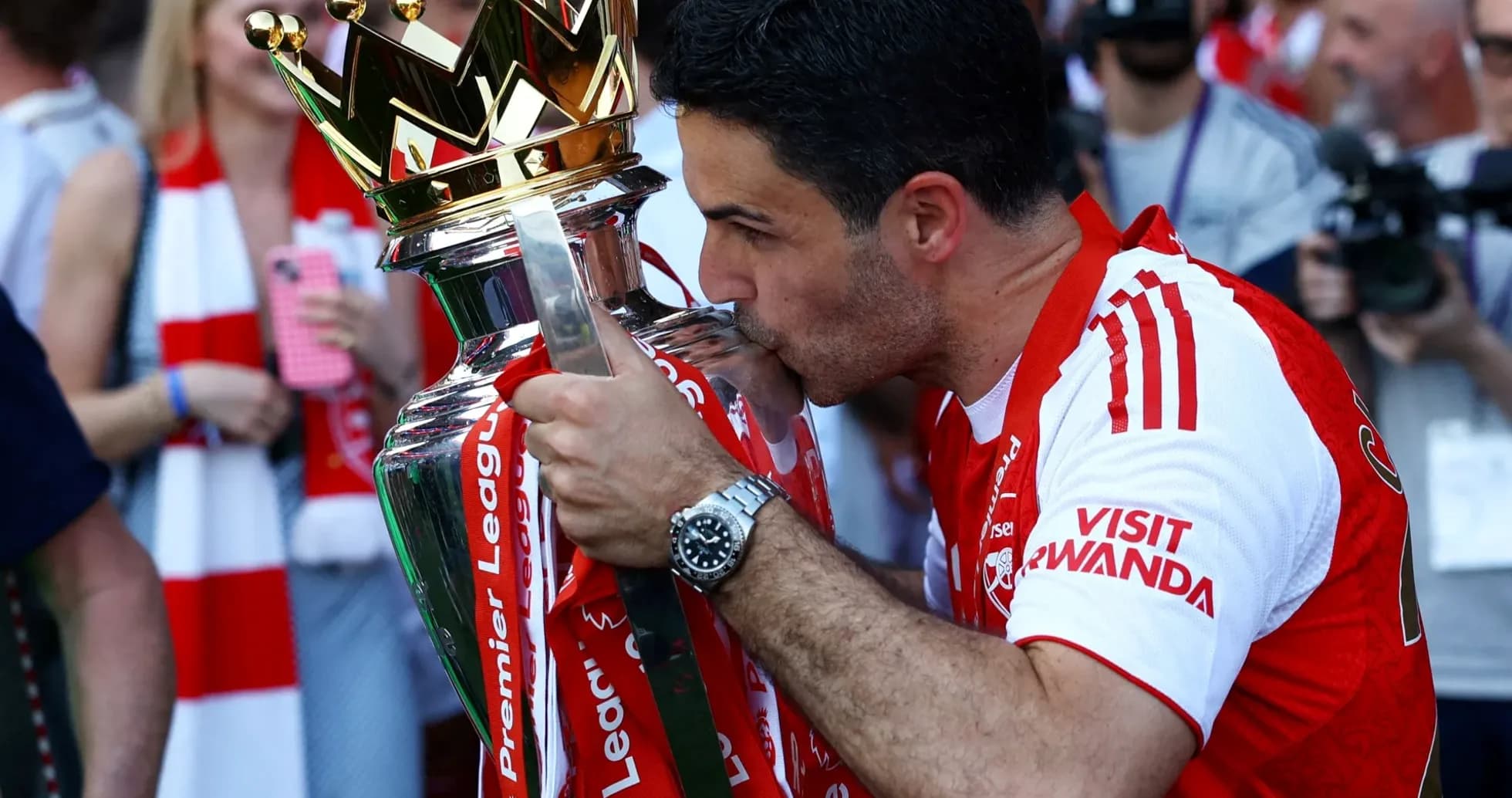 Manager kissing Premier League trophy in celebration