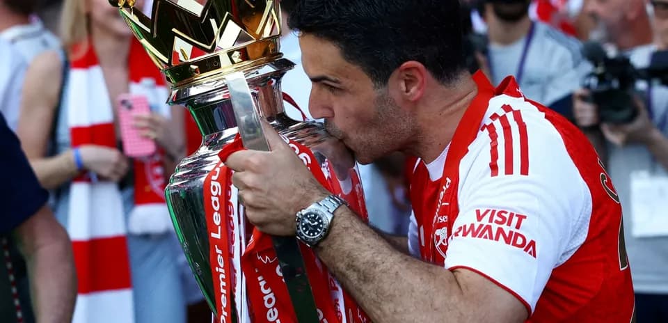 Manager kissing Premier League trophy in celebration