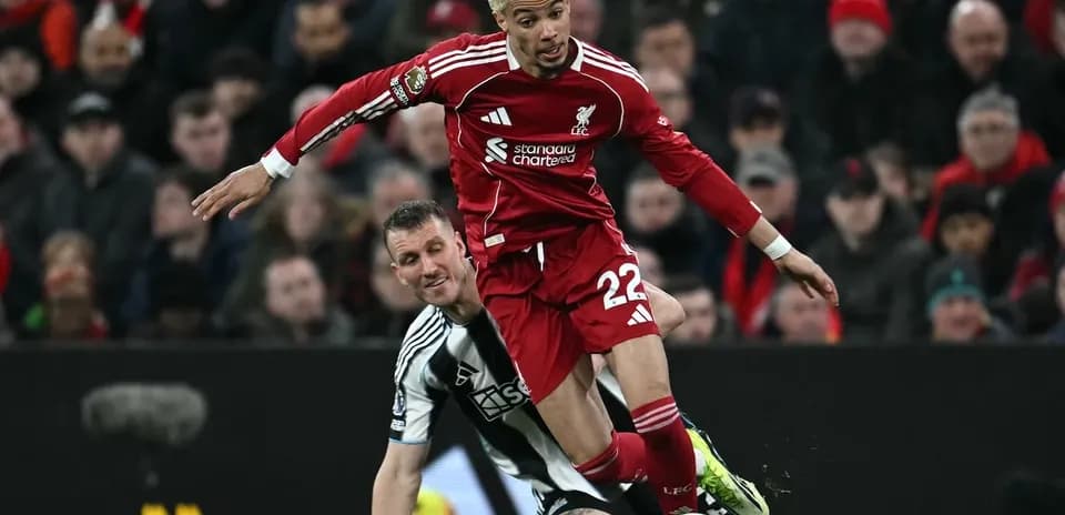 Liverpool player challenged by Newcastle defender