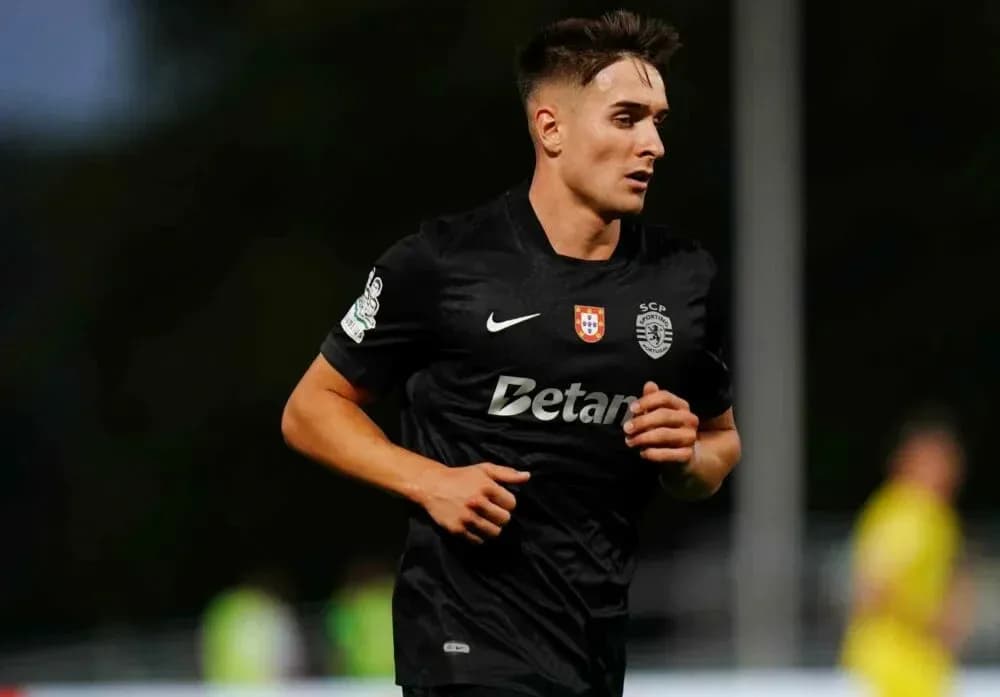 Player running during a football match in black kit