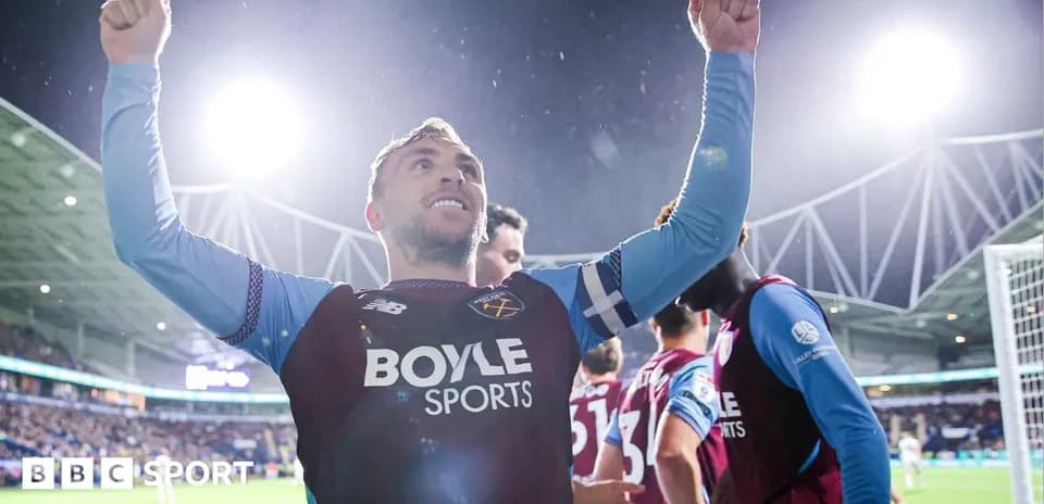 Player celebrating with raised arms after scoring goal