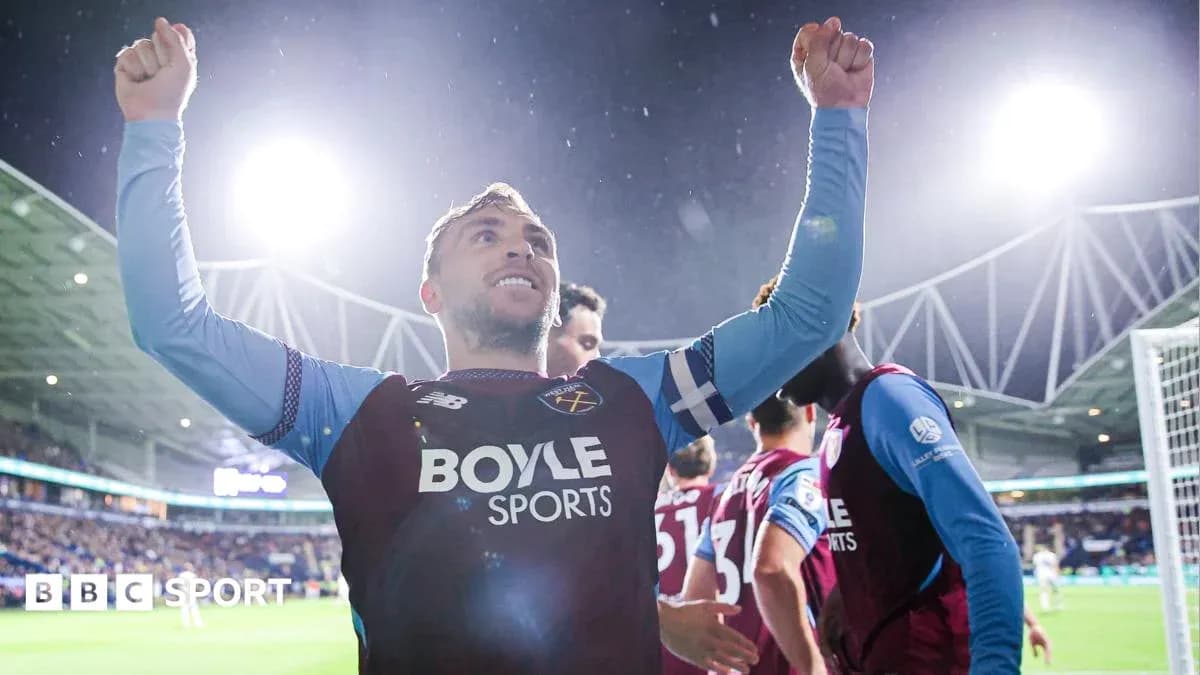 Player celebrating with raised arms after scoring goal