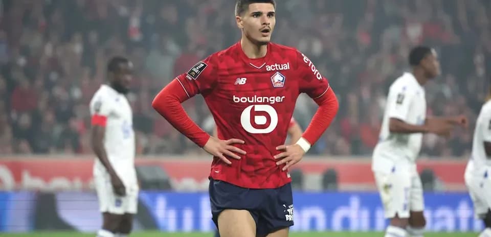 Lille player with hands on hips during match