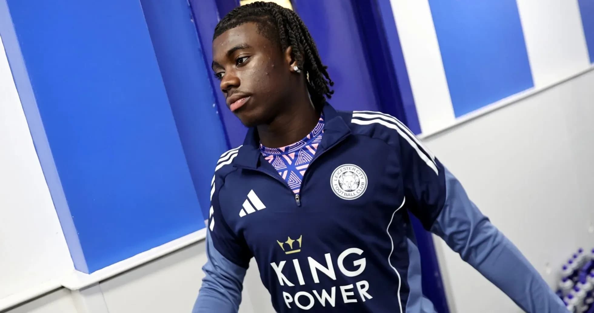 Player in Leicester City training gear entering facility