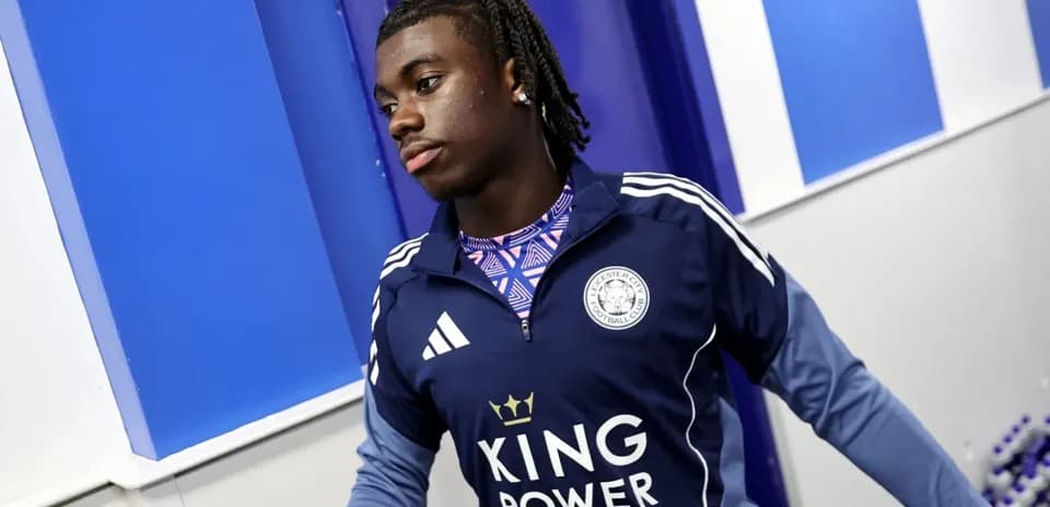 Player in Leicester City training gear entering facility