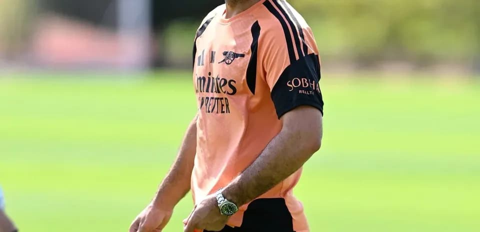 Manager smiling during training session on pitch