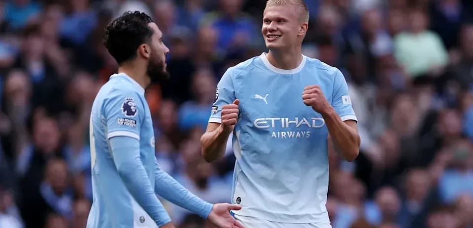 Two Manchester City players celebrating a goal