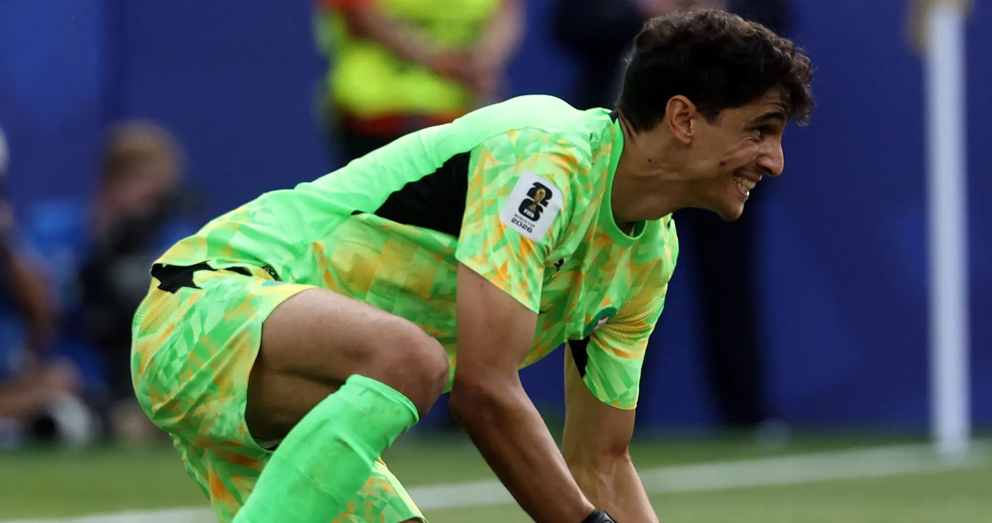 Goalkeeper in bright green kit preparing for play