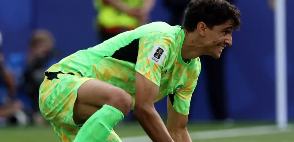 Goalkeeper in bright green kit preparing for play