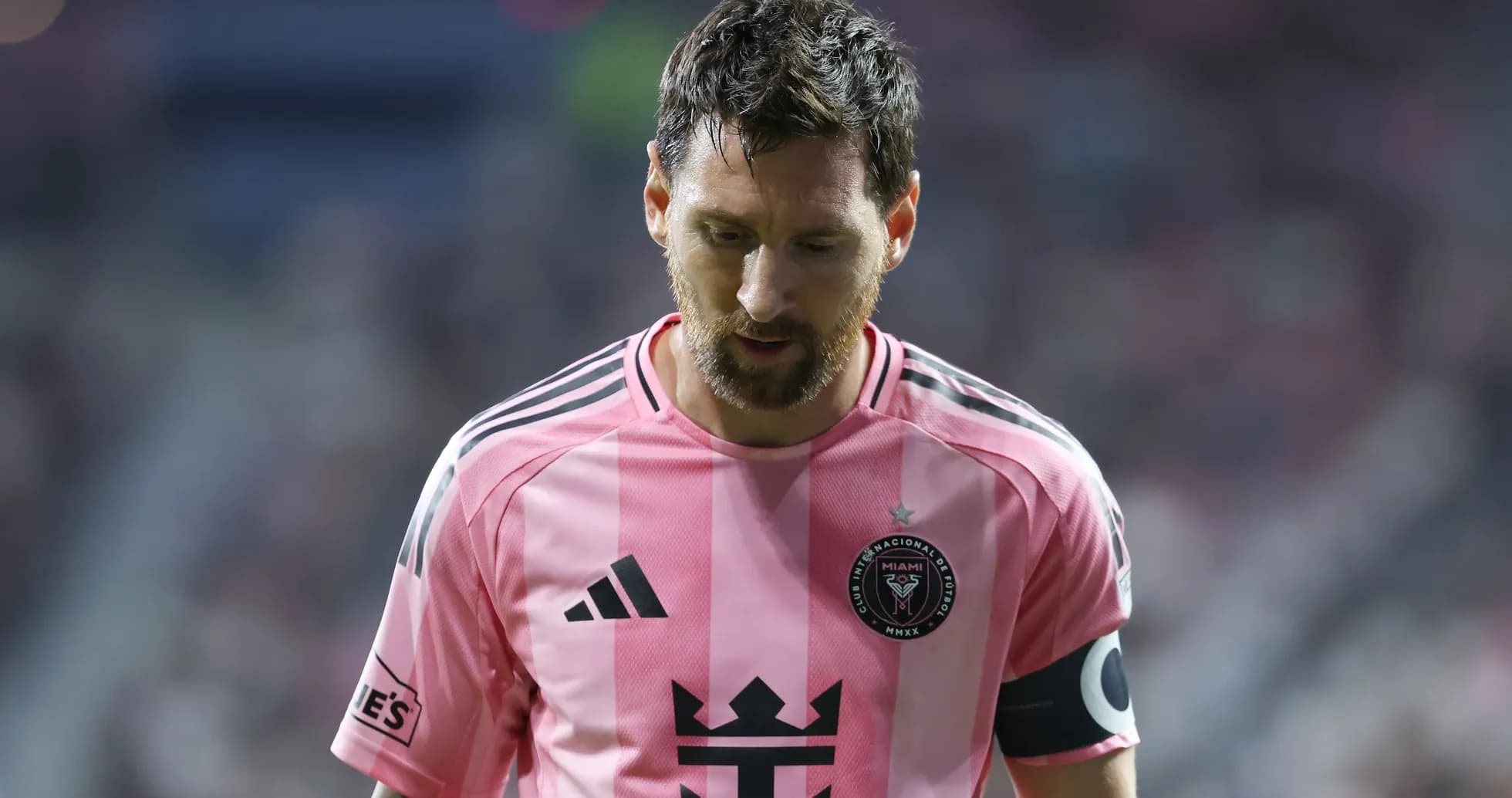Player in pink jersey looking down during match