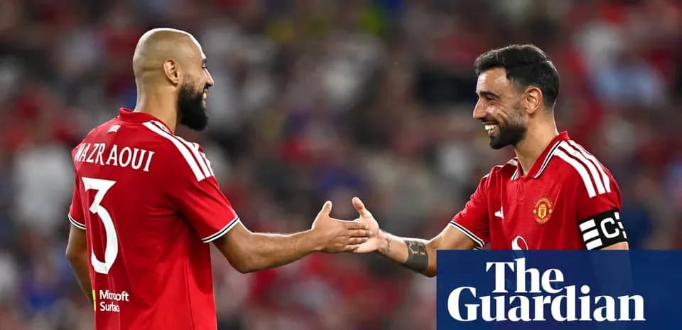 Two Manchester United players exchanging handshakes