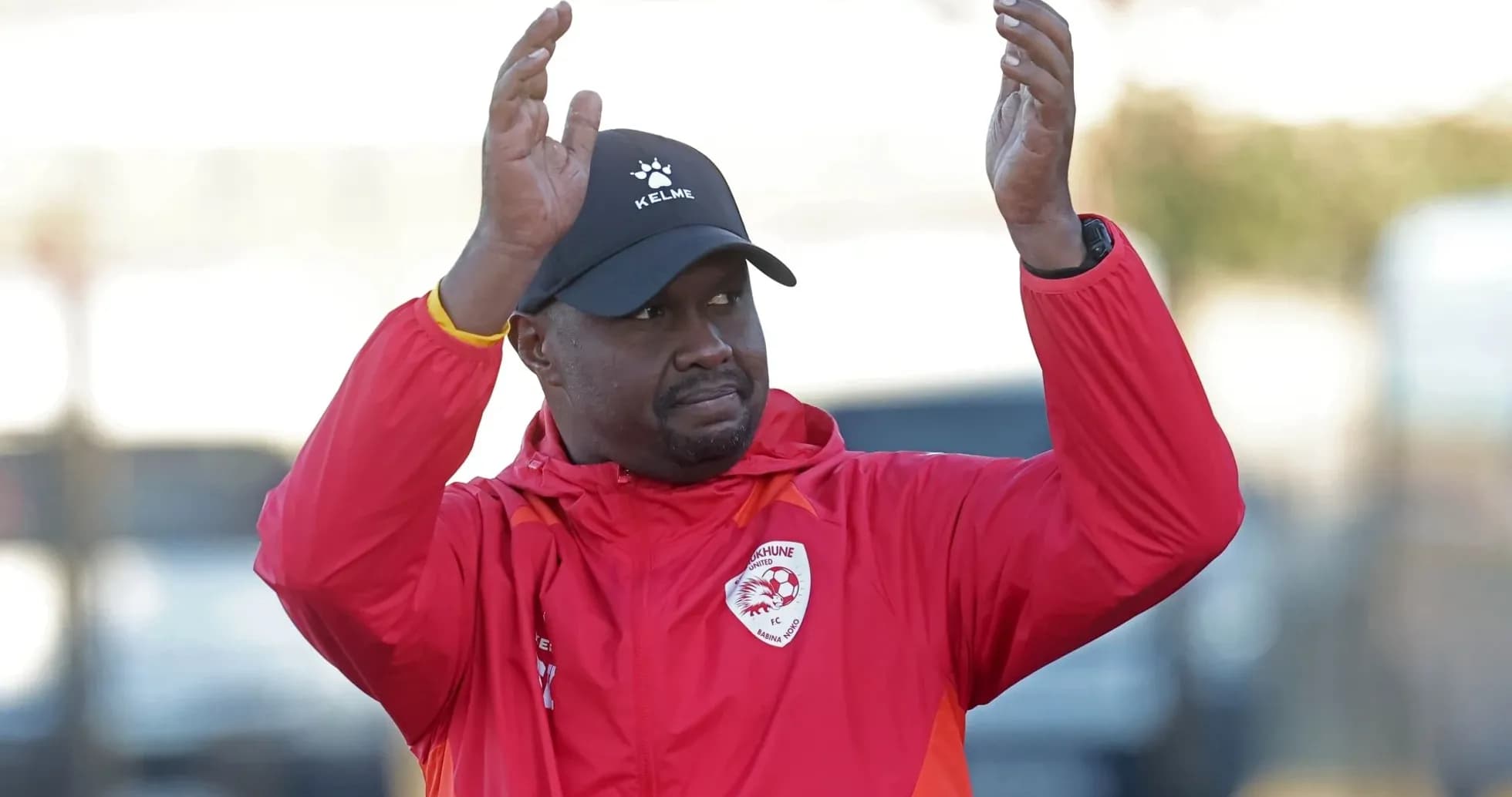 Coach applauding during training session outdoors