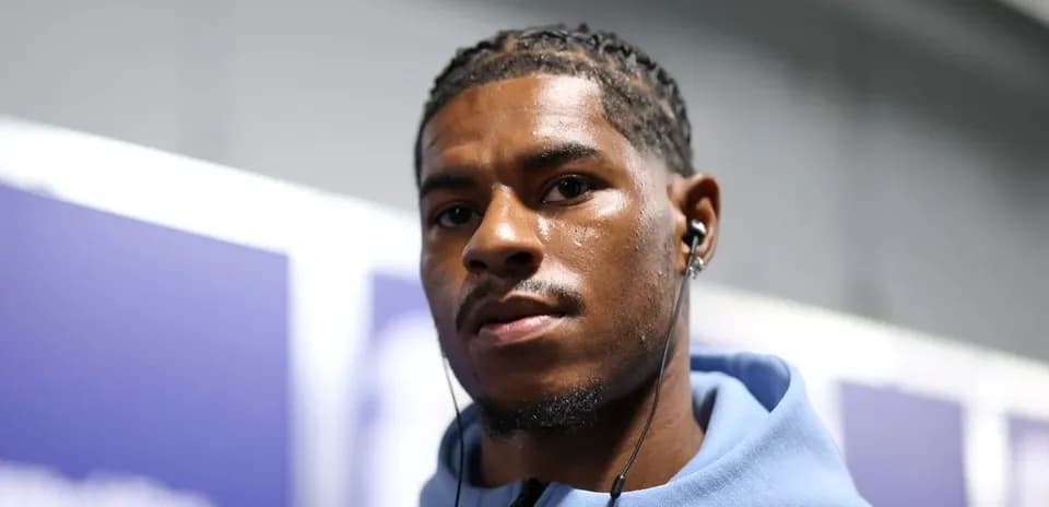 Athlete wearing headphones in a hallway