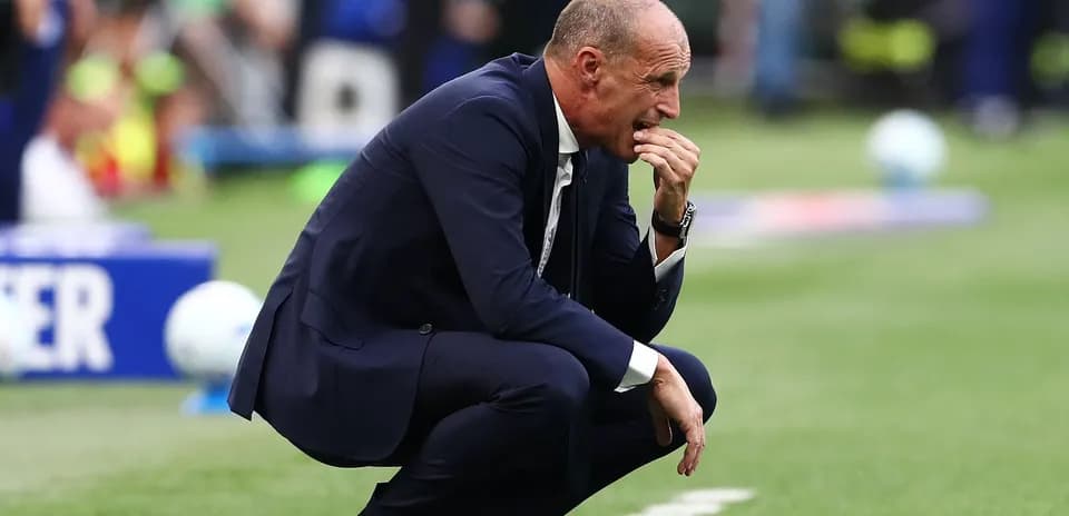 Coach kneeling and contemplating during match